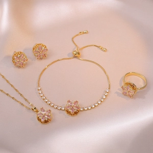 Elegant gold-tone jewelry set featuring pink zircon flower necklace, bracelet and earrings