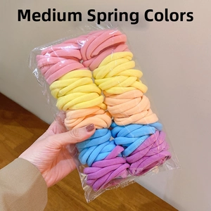 Macro detail of high-elasticity medium hair ties in vibrant pastel spring colors