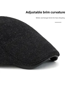 Detail of herringbone wool newsboy cap showing the bendable leather brim edge