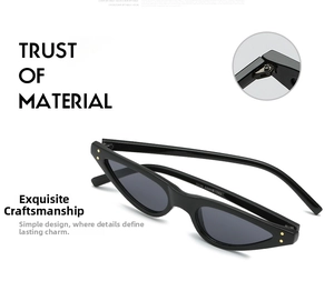 Detail view of black cat-eye sunglasses featuring golden metallic rivets and hinge structure