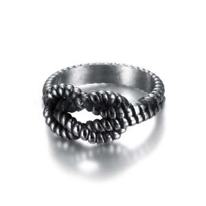 Macro detail of vintage silver stainless steel ring with braided rope texture