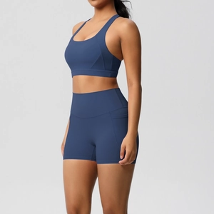 Detail of high-waist yoga shorts with side pocket in a navy blue athletic set