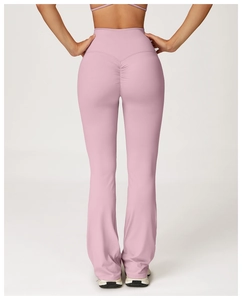 Detail of pink high-waisted flare yoga pants showing scrunch butt design from back view