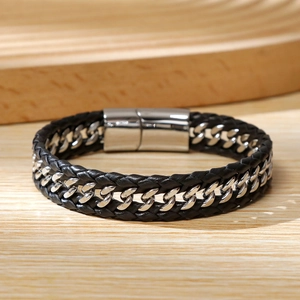Detail of men's Cuban chain and black braided leather bracelet with silver magnetic clasp