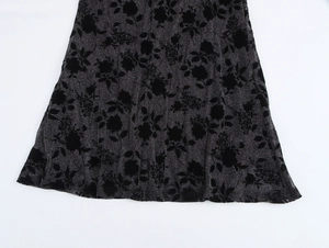 Macro shot of black floral jacquard fabric with elegant silver glitter threads