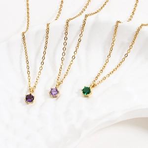 Detailed close-up of 18K gold plated necklaces with purple and green zircon pendants