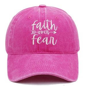 Detail of white Faith over Fear embroidery on washed rose red cotton baseball cap