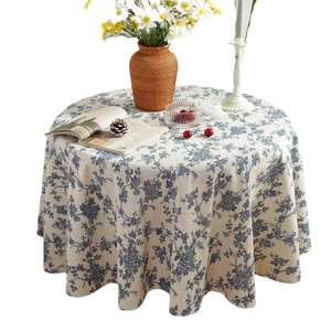 Blue and white floral cotton linen round tablecloth displayed on a vintage tea table