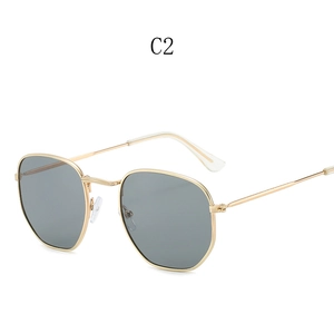 Detail of gold hexagonal metal frame sunglasses with dark grey polarized lenses