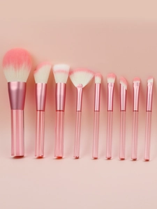 Detail view of soft pink gradient bristles and transparent acrylic handles of makeup brushes
