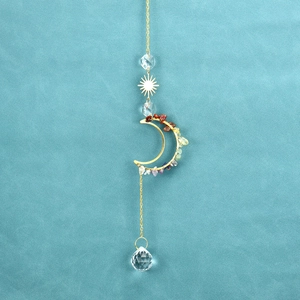 Detailed view of moon and sun suncatcher with colorful chakra stones and crystal ball