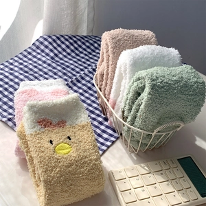 Close-up of cute cartoon chick embroidery on soft, thick coral fleece fuzzy socks