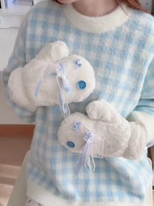 Detail of white plush mittens featuring light blue silk bow and delicate lace trim