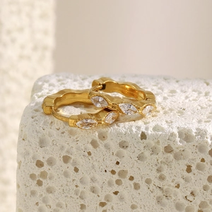 Macro view of gold plated 18K stainless steel hoop earrings with marquise cut zircon