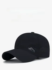Close-up of black breathable mesh baseball cap featuring mountain logo and side laser-cut holes