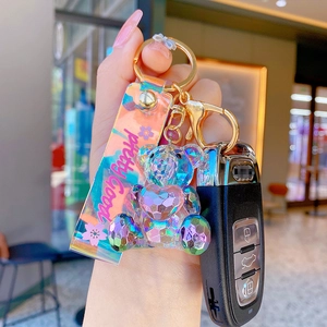 Geometric crystal bear keychain with colorful gradient finish and leather wrist strap