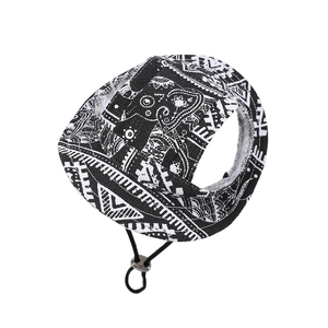 Detail of black and white canvas dog hat featuring ear holes and adjustable chin strap