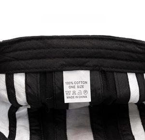 Detailed view of the 100% cotton washing label and inner stitching on the beret hat