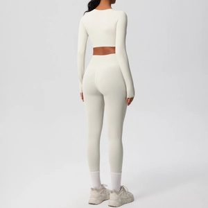 Detail view of the seamless high-waist yoga leggings and long sleeve cropped top from behind