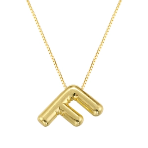 Macro shot of polished gold balloon letter F pendant on a fine box chain necklace