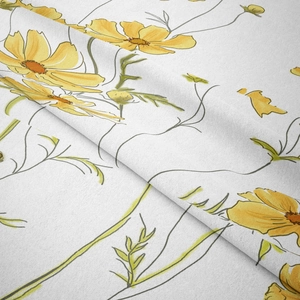 Close-up of soft brushed fabric with vibrant yellow floral cosmos pattern and texture