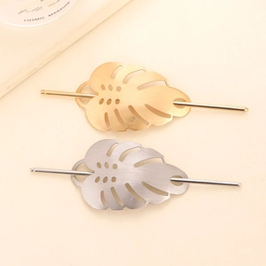 Minimalist gold and silver monstera leaf hair pins in brushed alloy metal