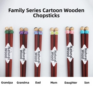 Detail showing set of six natural wooden chopsticks with cute cartoon family heads