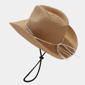 Brown woven straw cowboy sun hat with adjustable white wind strap for summer travel