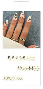Detail of almond press-on nails with black abstract lines and bowknot design JP3850