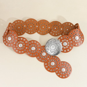 Detail of a brown leather disc belt with silver floral buckle and metal ring accents