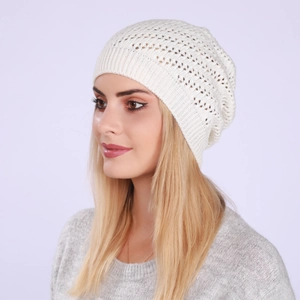 Close-up of the delicate hollow-out knit pattern and ribbed cuff of the beige beanie hat
