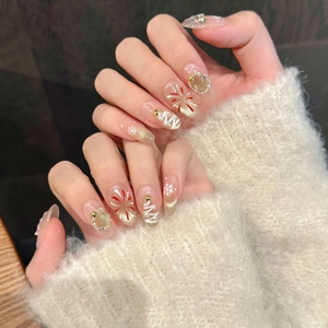 Detail of almond-shaped press-on nails with 3D Christmas tree and snowflake art
