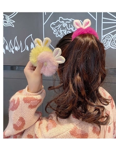 Close-up of soft plush rabbit ear hair ties in vibrant colors worn on hair