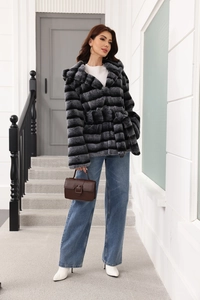 Belted hooded faux fur coat with grey gradient stripes worn with white boots and jeans