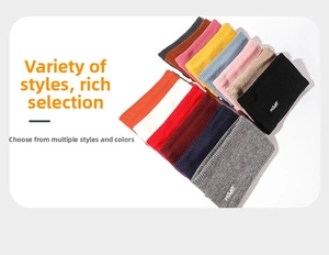 Close-up of thick knitted infinity scarves in multiple colors with small embroidery details