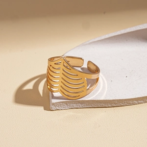 Detail of golden adjustable open ring featuring unique hollowed leaf vein patterns