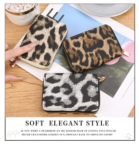 Three leopard print card holders in gold, brown, and grey with golden zipper details