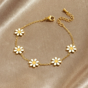 Golden stainless steel chain bracelet featuring white enamel daisy flower pendants for women