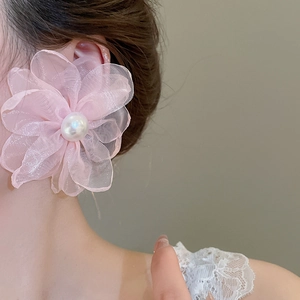 Detail of pink chiffon flower earring with large pearl on model side view