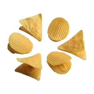 Detail showing creative snack-shaped potato chip and tortilla hair clips on white background