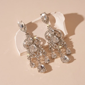 Luxury silver-tone chandelier earrings with sparkling drop crystals on stone display