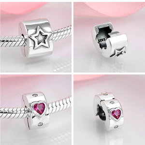 Detail showing S925 sterling silver charms with pink heart stones and star patterns