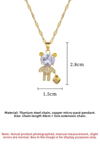 Macro view of crystal-encrusted teddy bear pendant with golden heart in titanium steel