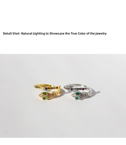 Close-up of gold and silver snake rings with colorful zircon inlays and fine textures