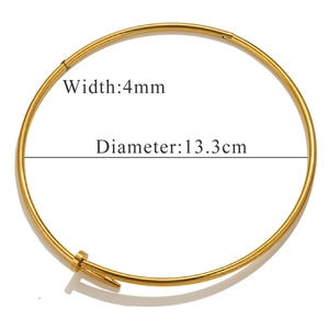 Macro view of gold nail collar necklace showing 4mm width and 13.3cm diameter