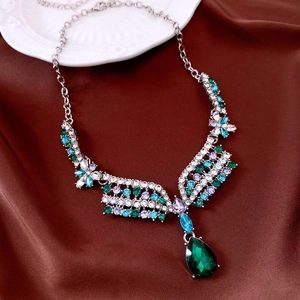 Close-up of vintage flower pendant necklace with multi-color crystals on brown silk