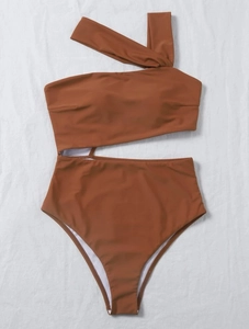 Detail of one-shoulder cutout swimsuit in caramel brown showing high-waist design