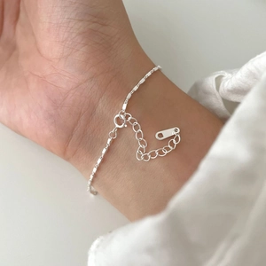 Minimalist S925 sterling silver square link chain bracelet worn on a woman's wrist