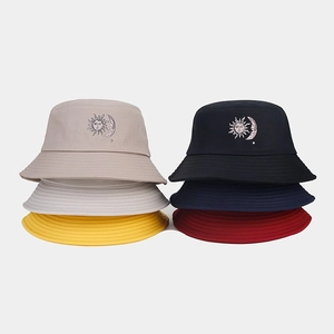 Close-up of sun and moon face embroidery on cotton bucket hats in six vibrant colors