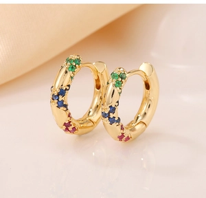 Detail of gold hinged hoop earrings featuring colorful micro-pave zirconia stones